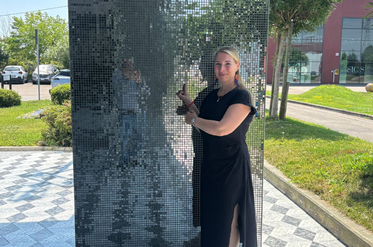 Angela Herrmann in front of a mosaic wall from SICIS Angela Herrmann in front of a mosaic wall from SICIS