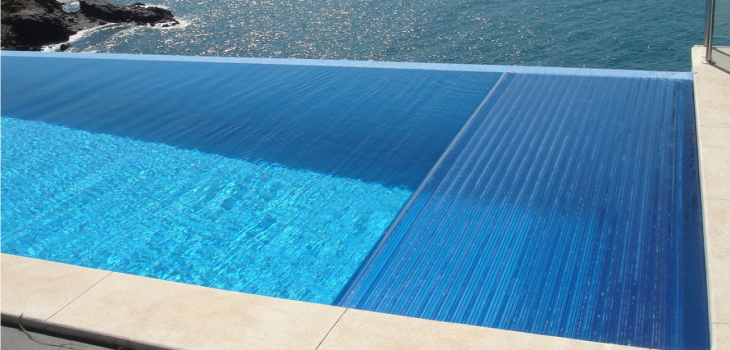 Automatic pool cover with crystal blue polycarbonate slats by Swim Safe
